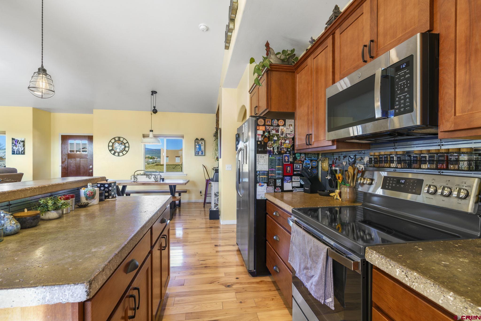 172 Encantado Lane Durango, CO 81303 - Photo 16 of 38 a kitchen with stainless steel appliances granite countertop a stove and a sink