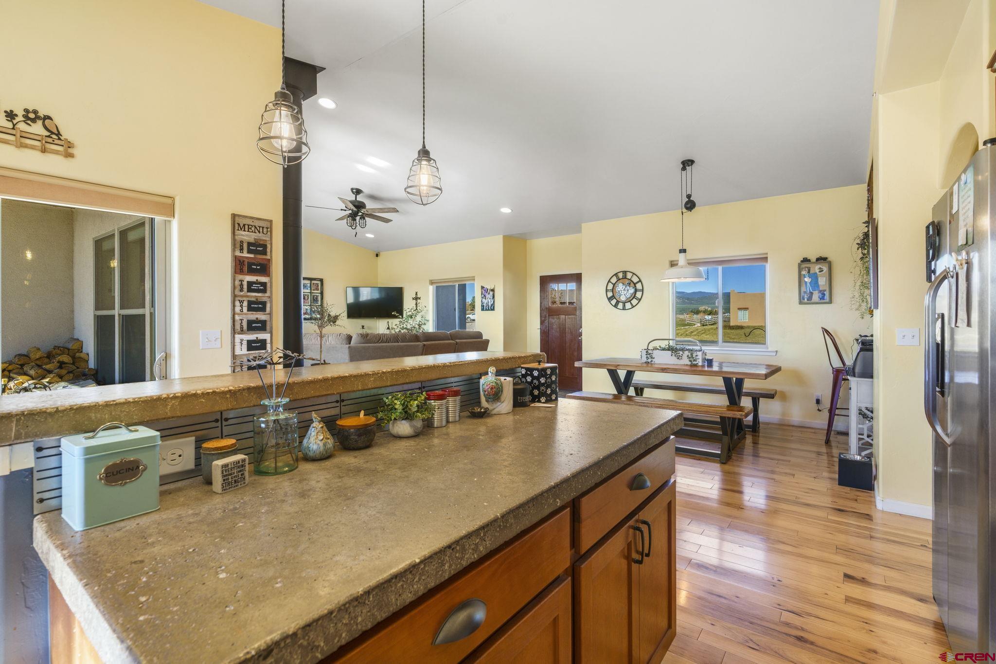 172 Encantado Lane Durango, CO 81303 - Photo 17 of 38 a kitchen with stainless steel appliances granite countertop a sink a stove and a wooden floors