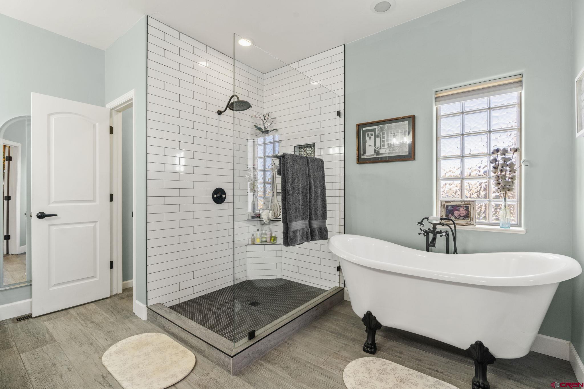 172 Encantado Lane Durango, CO 81303 - Photo 21 of 38 a bathroom with a tub shower sink mirror and toilet