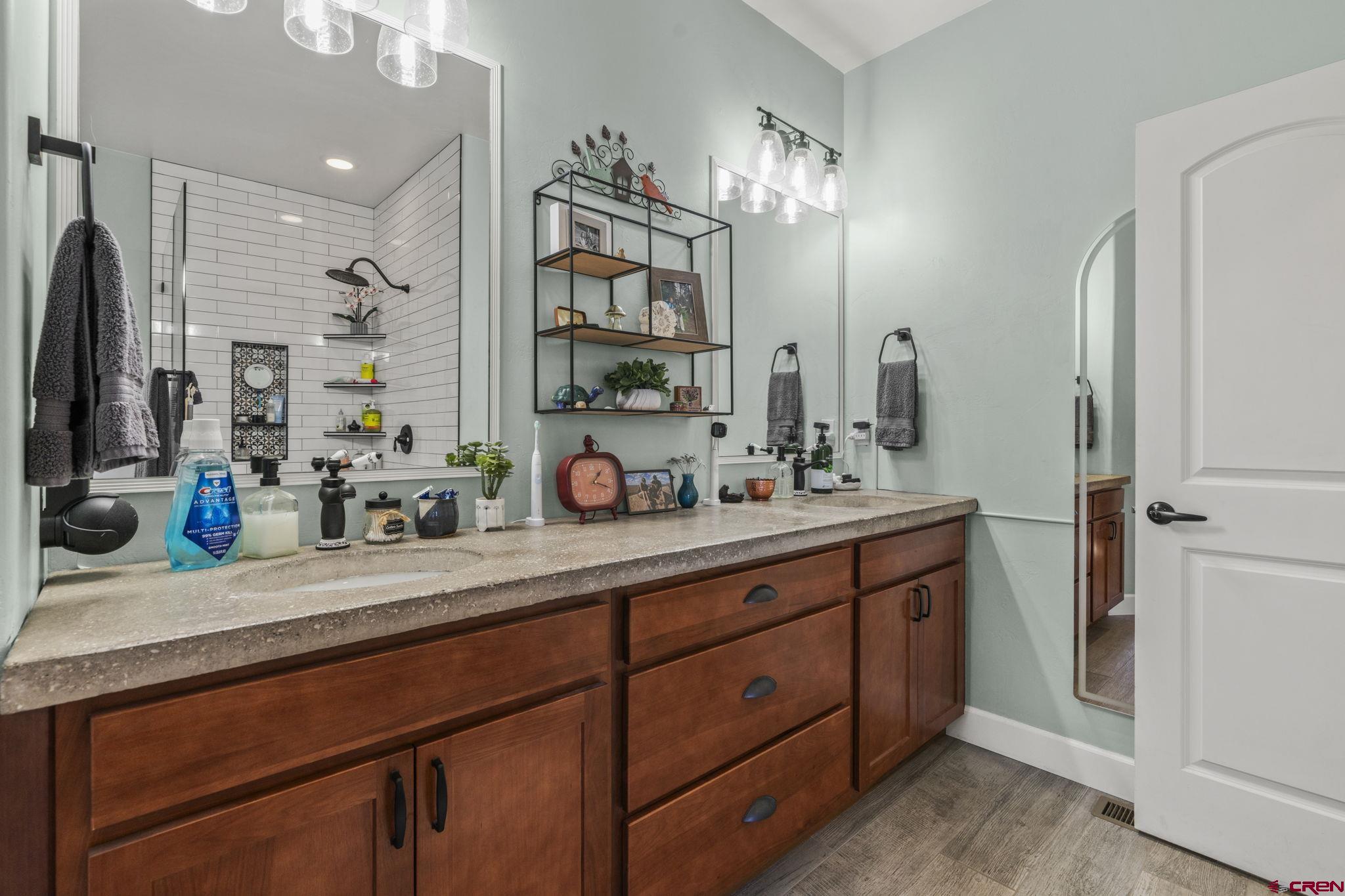 172 Encantado Lane Durango, CO 81303 - Photo 23 of 38 a bathroom with double vanity and a mirror