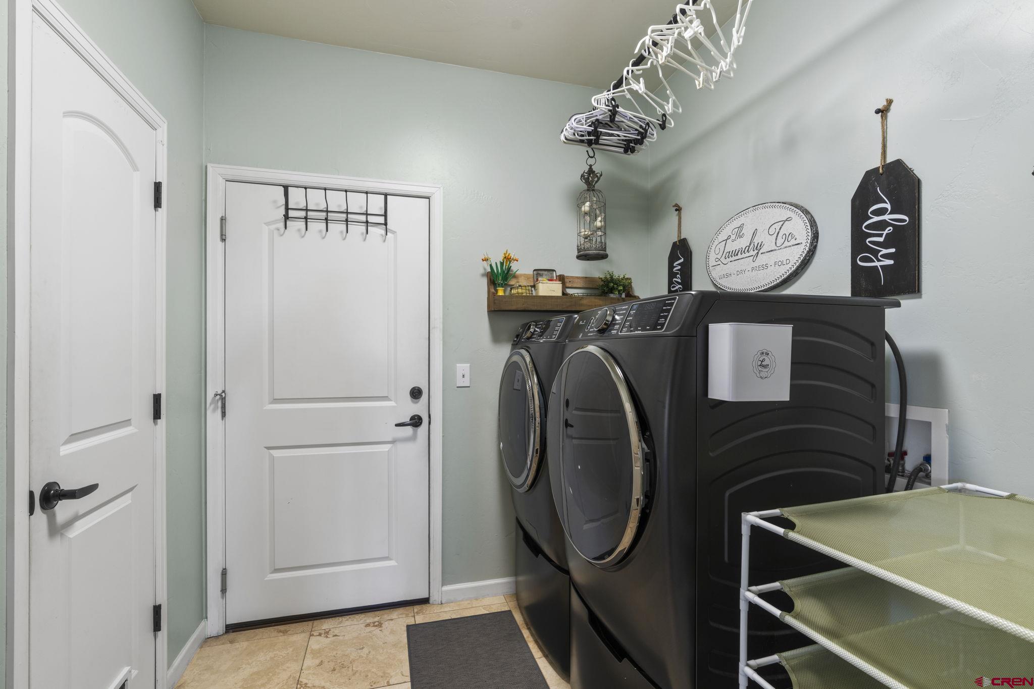 172 Encantado Lane Durango, CO 81303 - Photo 25 of 38 a view of a hallway with washer and dryer
