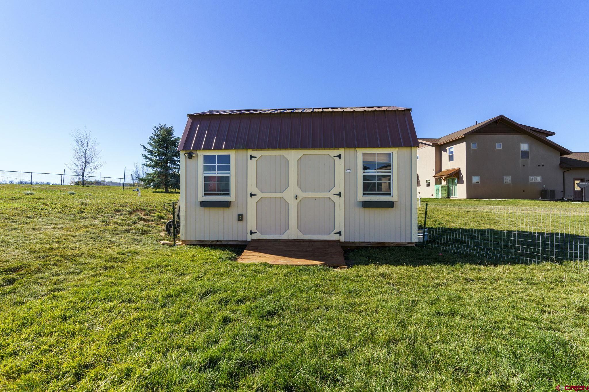 172 Encantado Lane Durango, CO 81303 - Photo 31 of 38 a view of a house with a yard