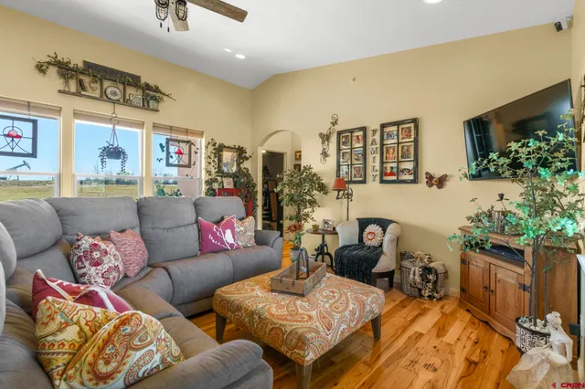 a living room with furniture and flowers