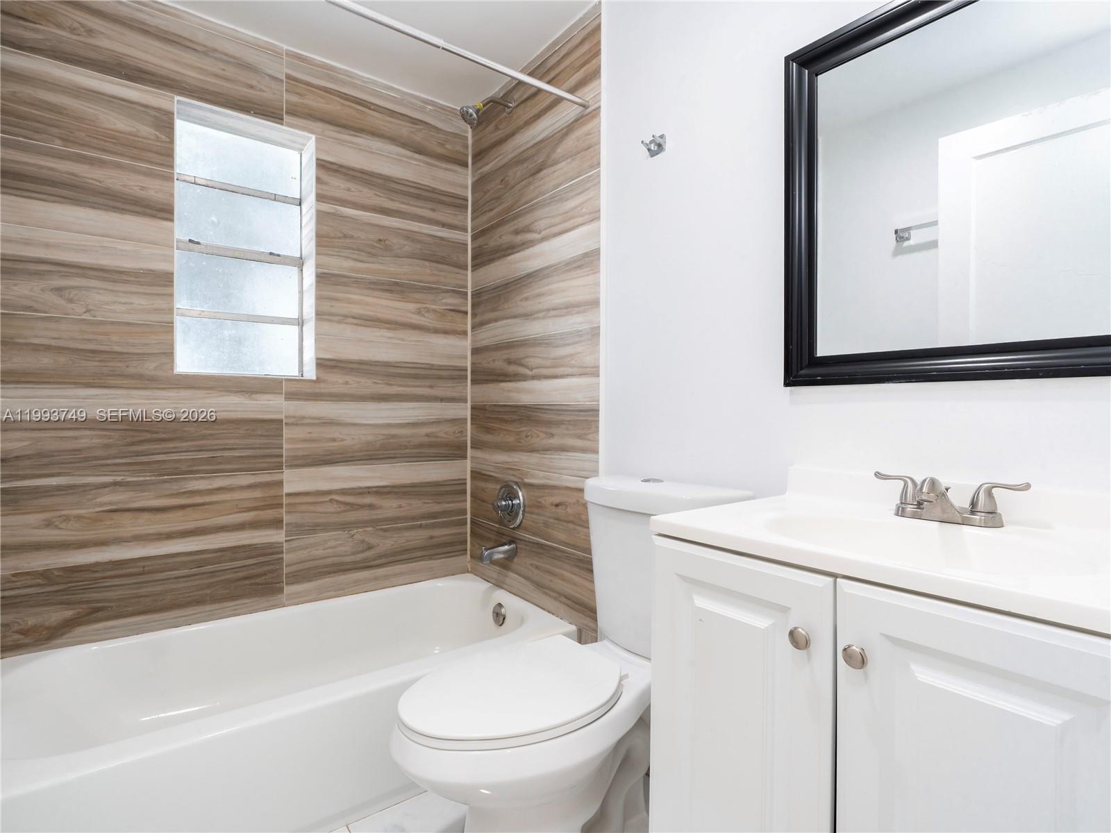 7635 Dickens Avenue, Unit 3 Miami Beach, FL 33141 - Photo 6 of 9 a bathroom with a sink toilet and shower