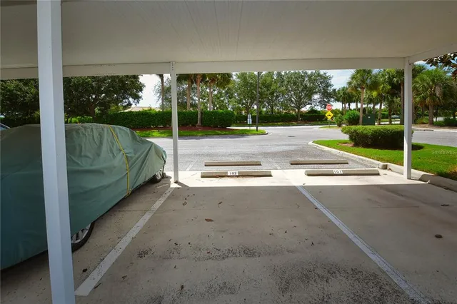 a view of a road with a big yard and a fountain