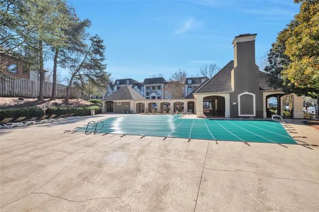 a view of house with a yard and potted plants