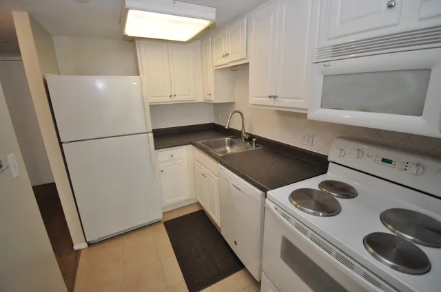 a white refrigerator freezer sitting inside of a kitchen