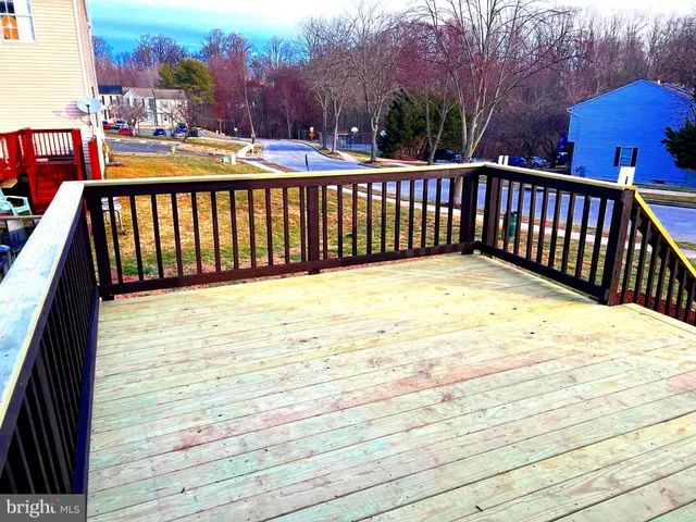 a view of balcony with wooden floor and fence