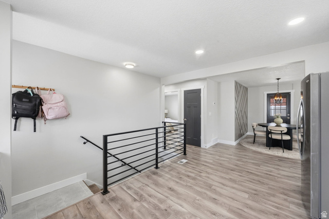 1795 South 200 West Bountiful, UT 84010 - Photo 11 of 37 Staircase with wood finished floors and hanging lights
