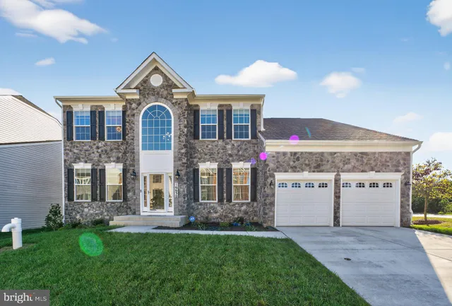 a view of a house with a yard and garage