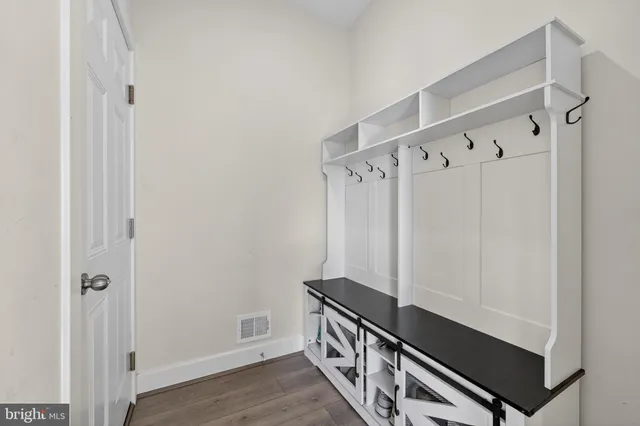 a view of an entryway with wooden floor