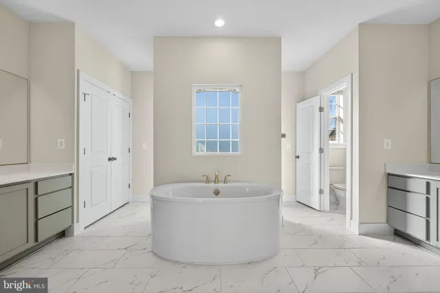 a bathroom with a sink a mirror and a bathtub