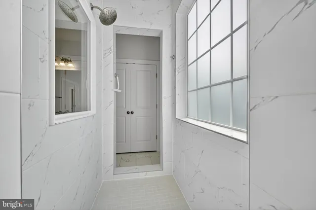 a spacious bedroom with a bed and a window