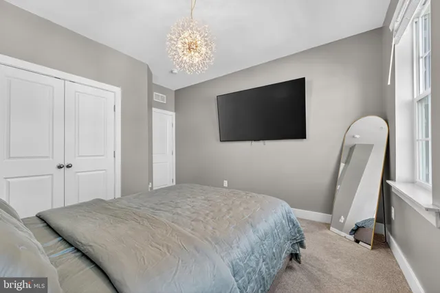 a bedroom with double bed and a window