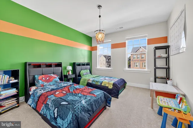 a bedroom with two beds and a chandelier