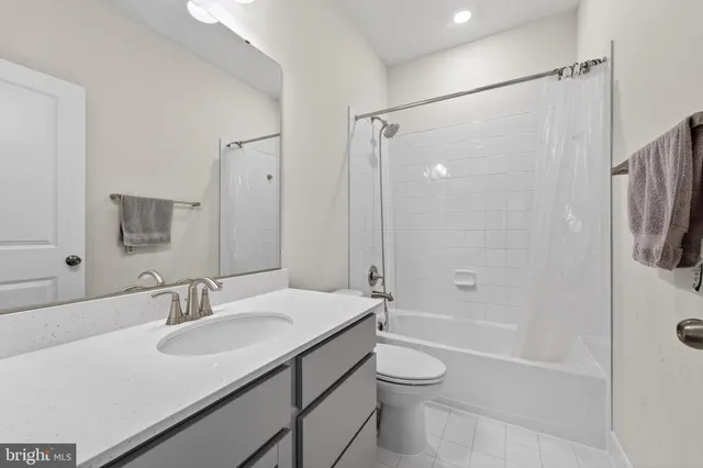 a view of an empty room with wooden floor and stairs