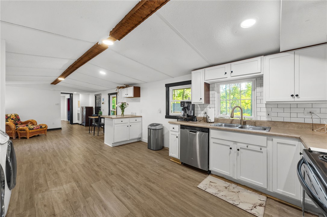 217 Old River Road Pelzer, SC 29669 - Photo 11 of 30 This spacious kitchen offers a seamless flow into the living area, featuring ample cabinetry and essential appliances.
