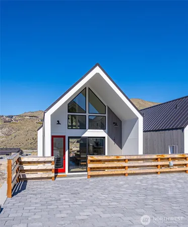 a view of a house with swimming pool and sitting area