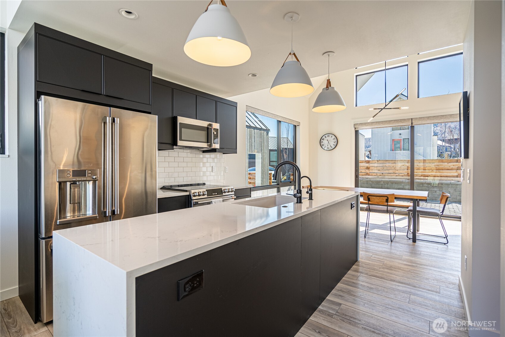 1418 Cottage Lane Chelan, WA 98816 - Photo 12 of 40 a kitchen with granite countertop a stove refrigerator and microwave