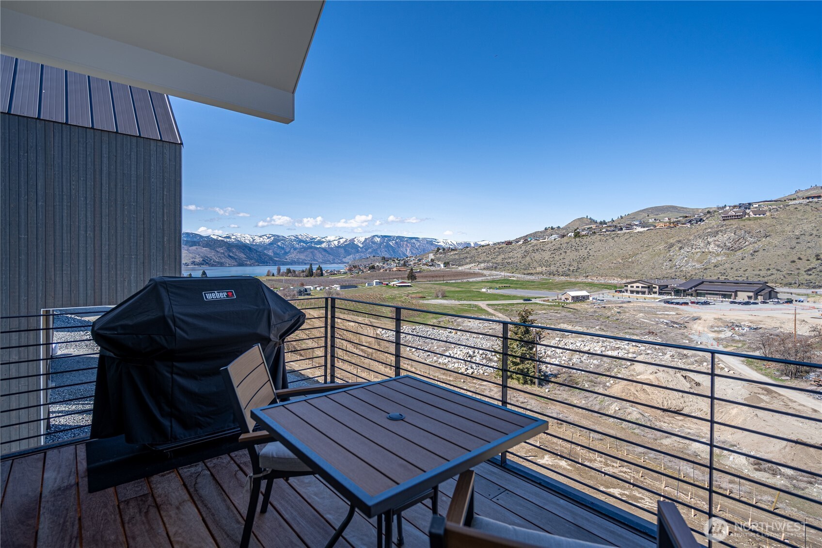 1418 Cottage Lane Chelan, WA 98816 - Photo 28 of 40 a view of a balcony with wooden floor and outdoor seating