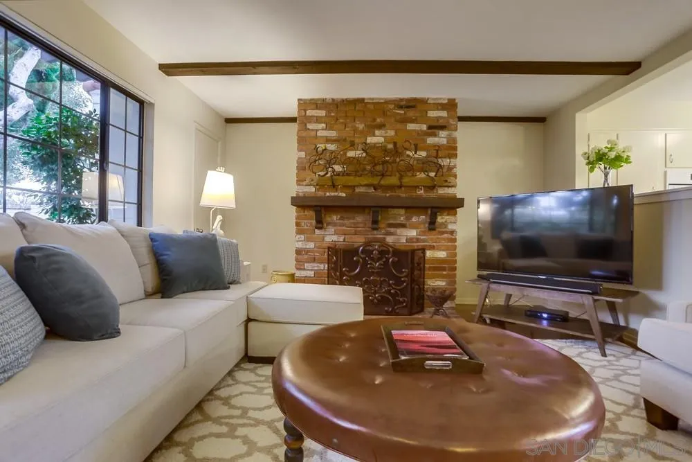 506 Pacific Avenue Solana Beach, CA 92075 - Photo 3 of 13 a living room with fireplace and a flat screen tv