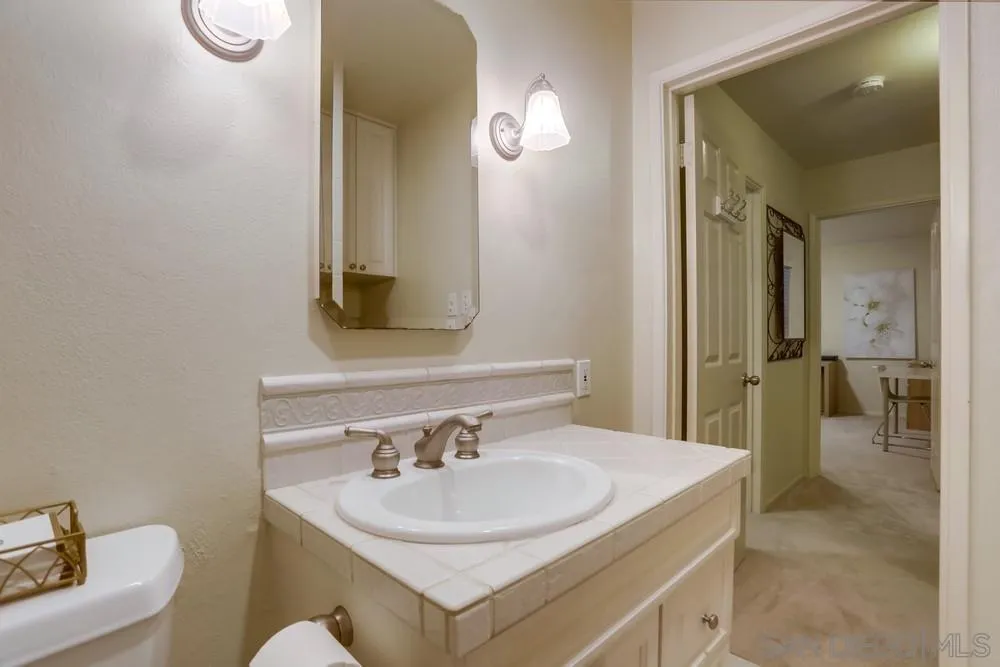 506 Pacific Avenue Solana Beach, CA 92075 - Photo 9 of 13 a bathroom with a sink and a mirror