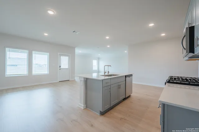 a view of kitchen with sink and wooden floor