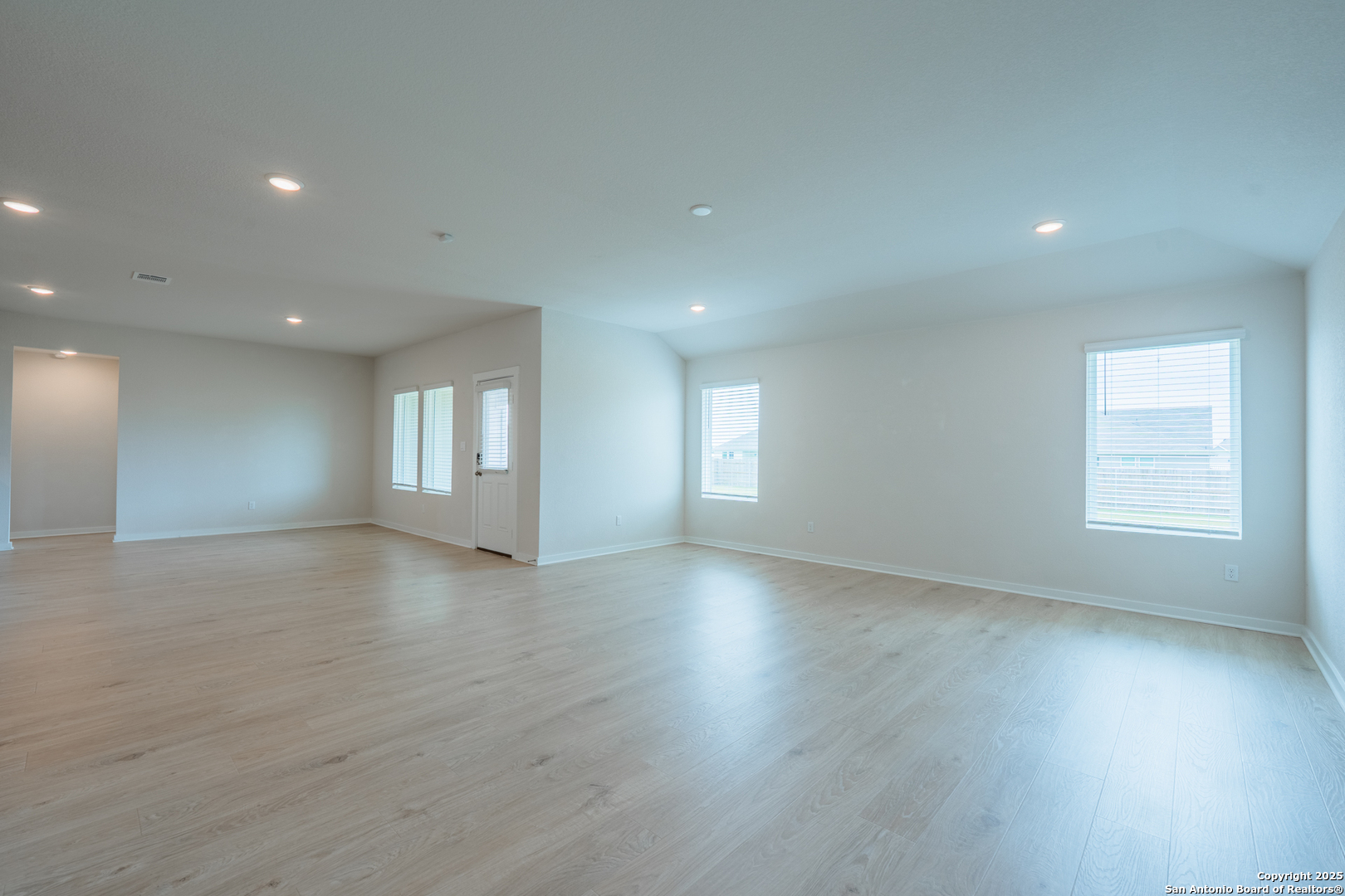 125 Nicks Cove Lockhart, TX 78644 - Photo 14 of 40 an empty room with wooden floor and windows