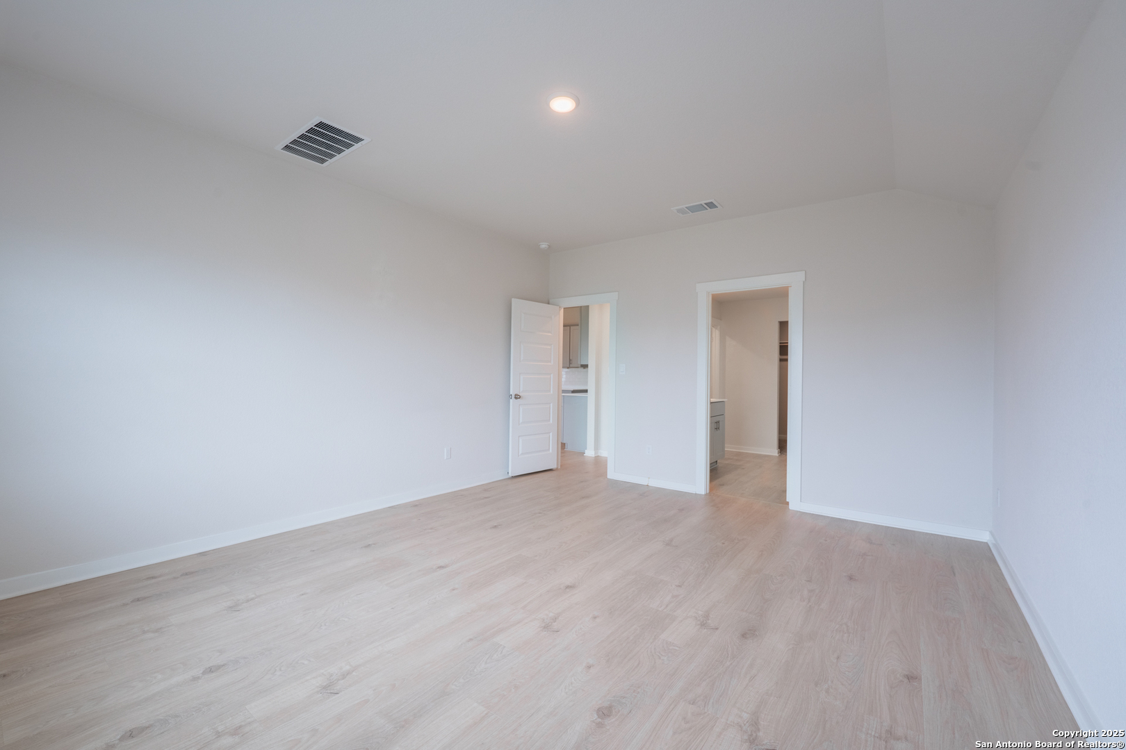 125 Nicks Cove Lockhart, TX 78644 - Photo 17 of 40 a view of an empty room with wooden floor and a window
