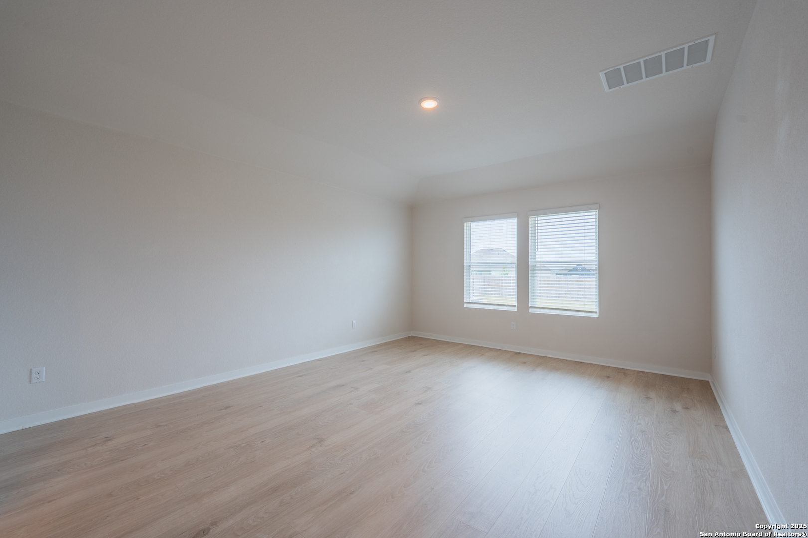 125 Nicks Cove Lockhart, TX 78644 - Photo 18 of 40 an empty room with wooden floor and windows