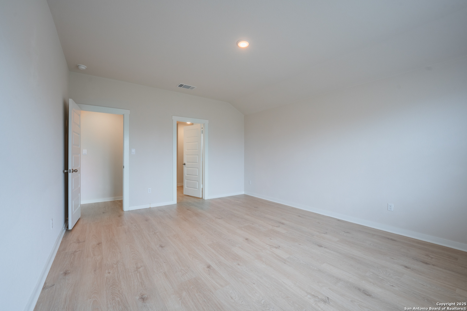 125 Nicks Cove Lockhart, TX 78644 - Photo 19 of 40 a view of an empty room with wooden floor