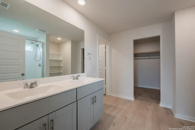 a bathroom with a double vanity sink and mirror