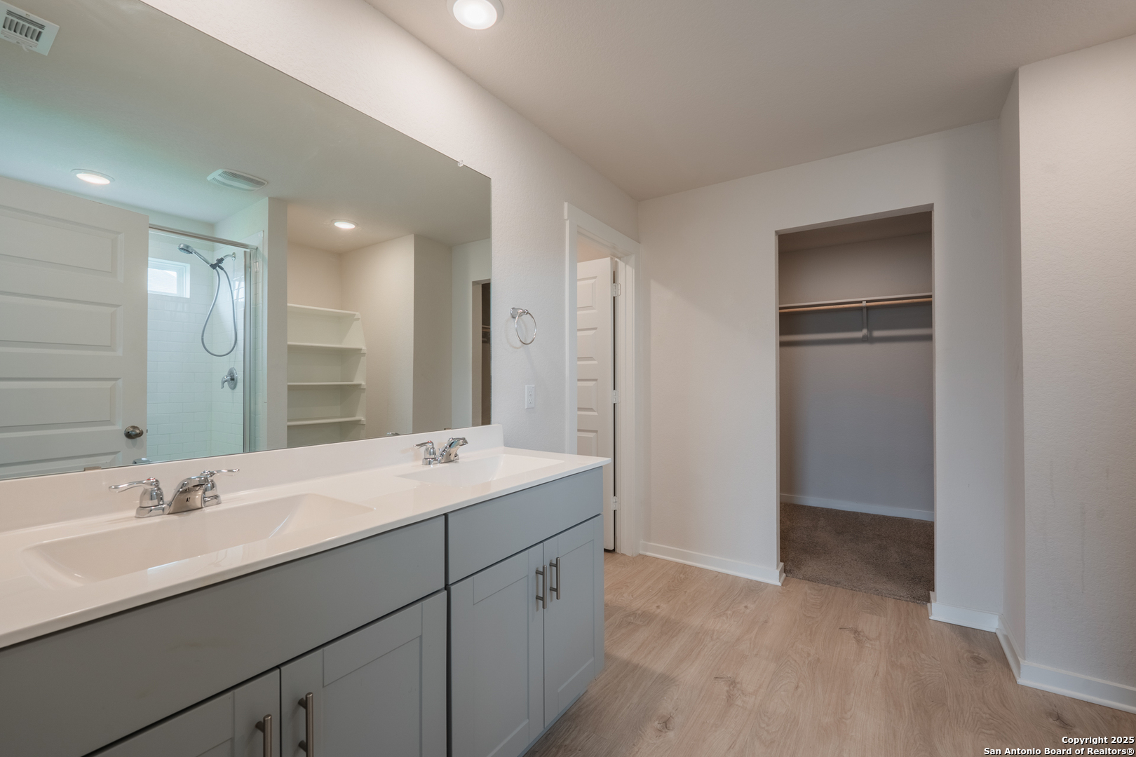 125 Nicks Cove Lockhart, TX 78644 - Photo 20 of 40 a bathroom with a double vanity sink and mirror