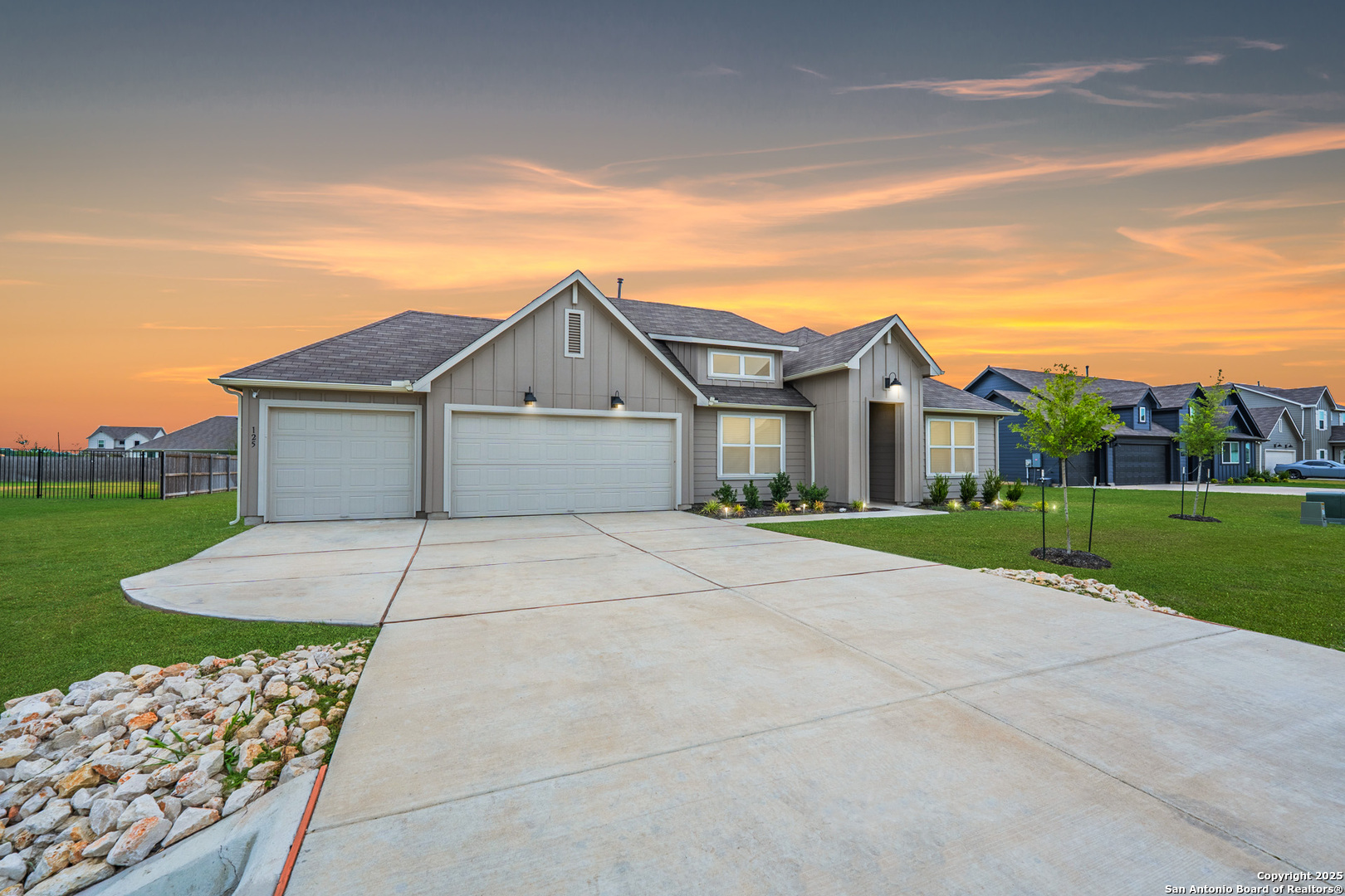 125 Nicks Cove Lockhart, TX 78644 - Photo 2 of 40 a view of a white house with a big yard and large trees