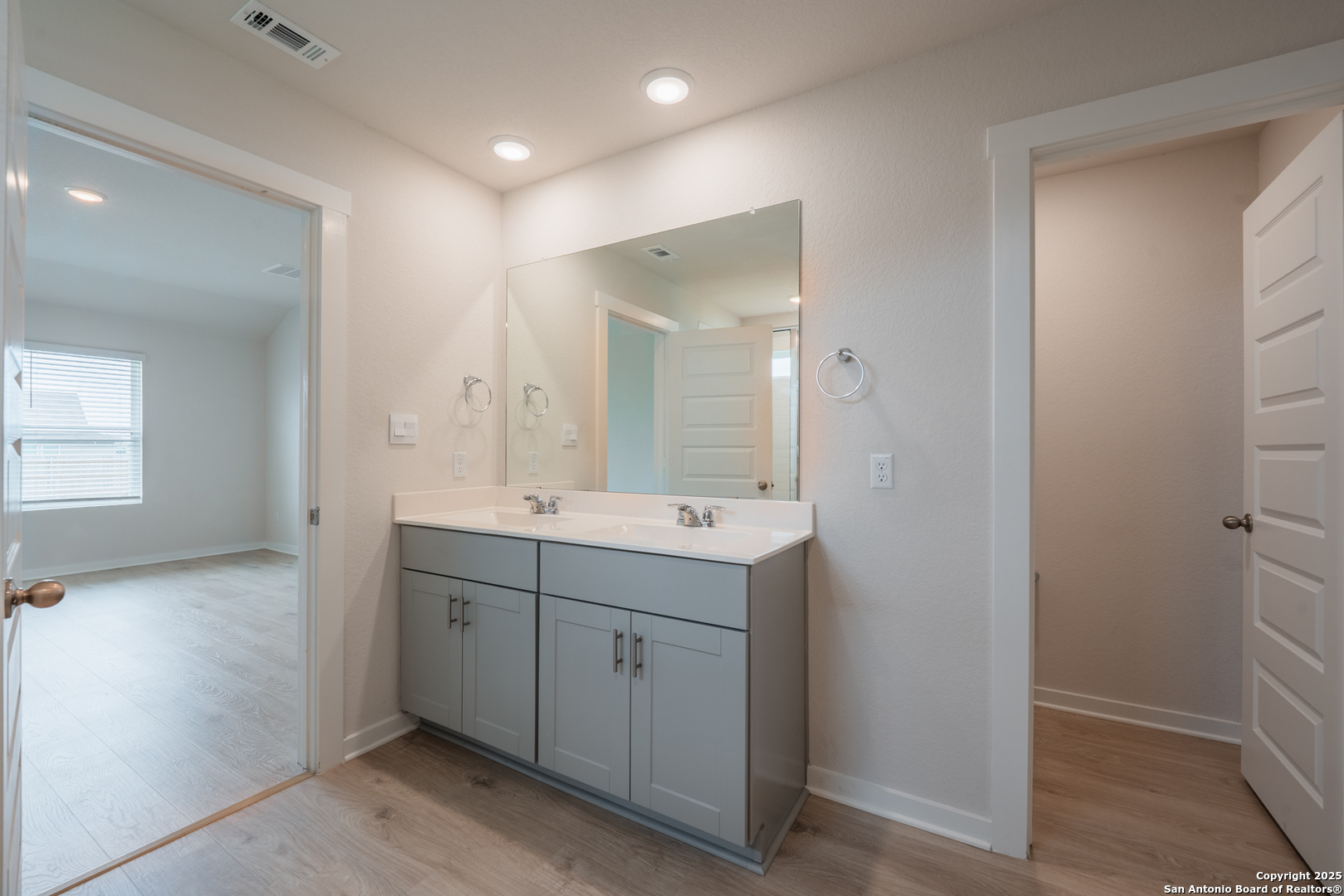 125 Nicks Cove Lockhart, TX 78644 - Photo 21 of 40 a bathroom with a double vanity sink and mirror