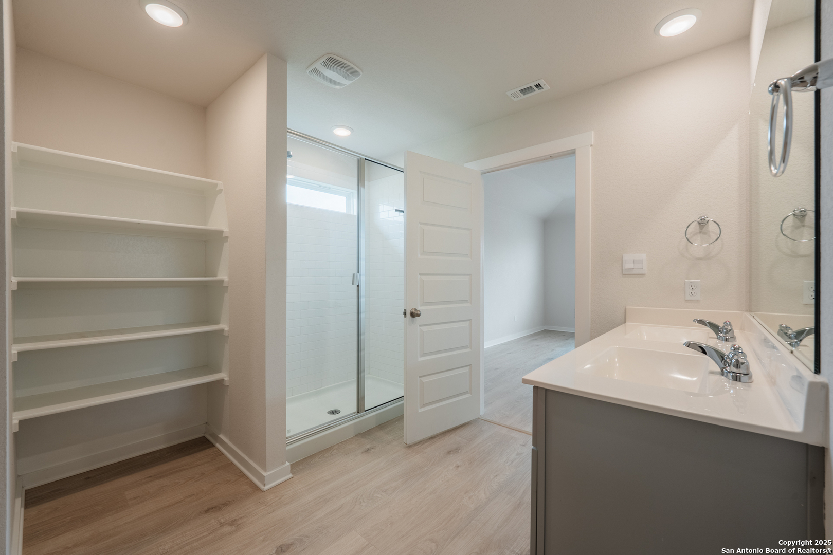 125 Nicks Cove Lockhart, TX 78644 - Photo 23 of 40 a bathroom with a sink and a mirror
