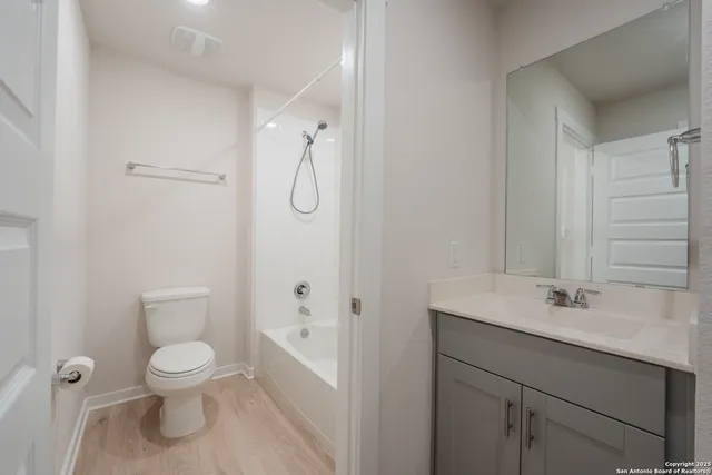 a bathroom with a toilet sink shower and mirror