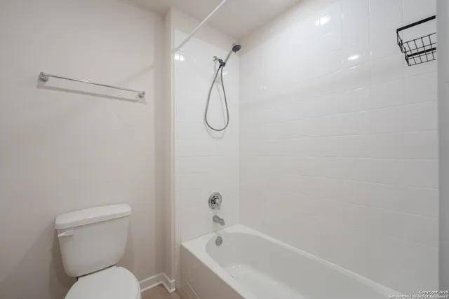 a bathroom with a toilet and a bath tub