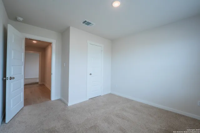 a view of an empty room and closet area