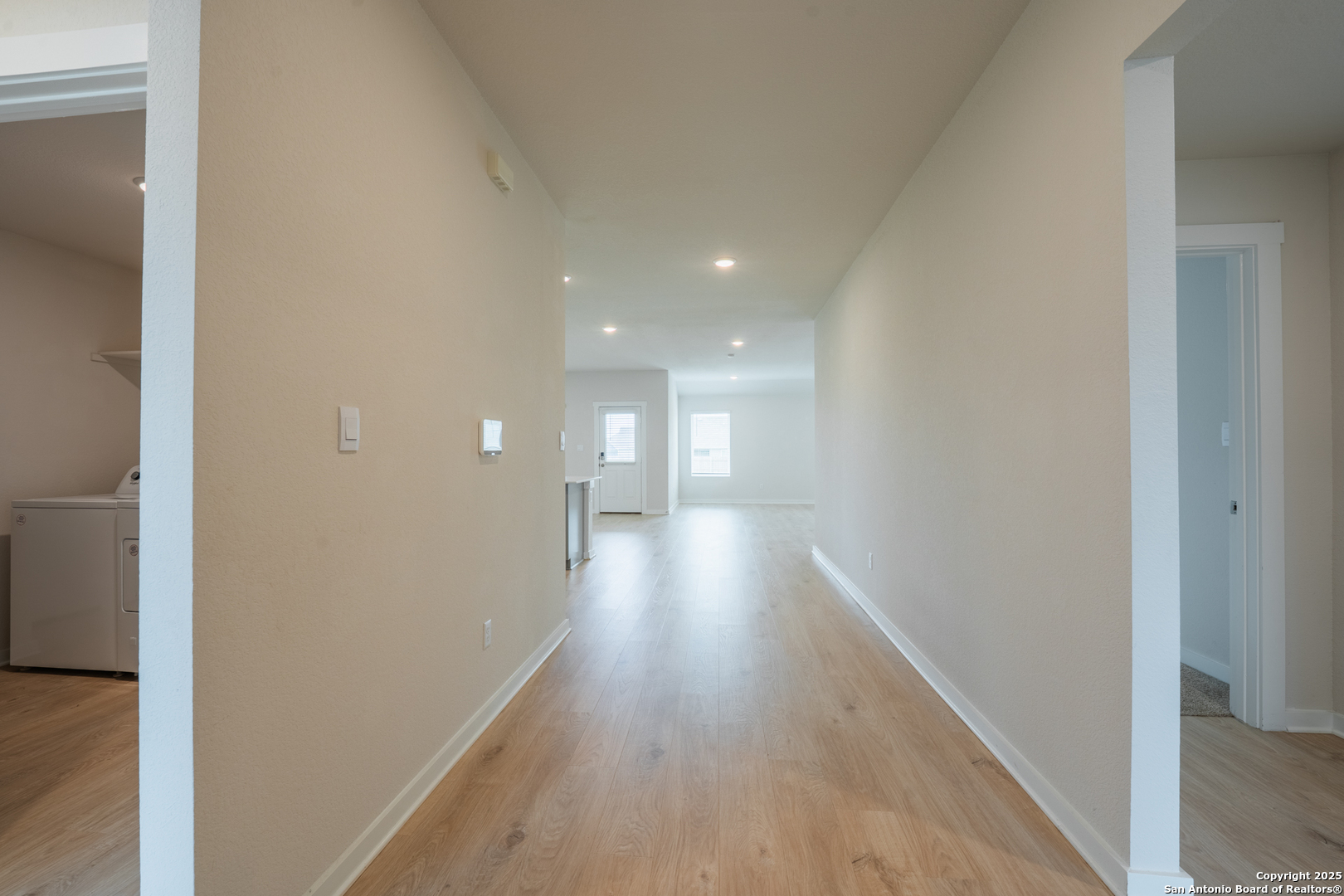 125 Nicks Cove Lockhart, TX 78644 - Photo 5 of 40 a view of a hallway with wooden floor