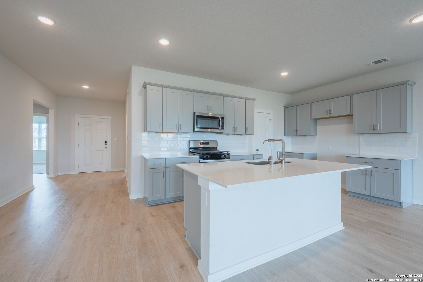 125 Nicks Cove Lockhart, TX 78644 - Photo 6 of 40 a kitchen with a sink a counter top space stainless steel appliances and cabinets