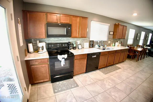 a kitchen with stainless steel appliances granite countertop a stove sink and cabinets