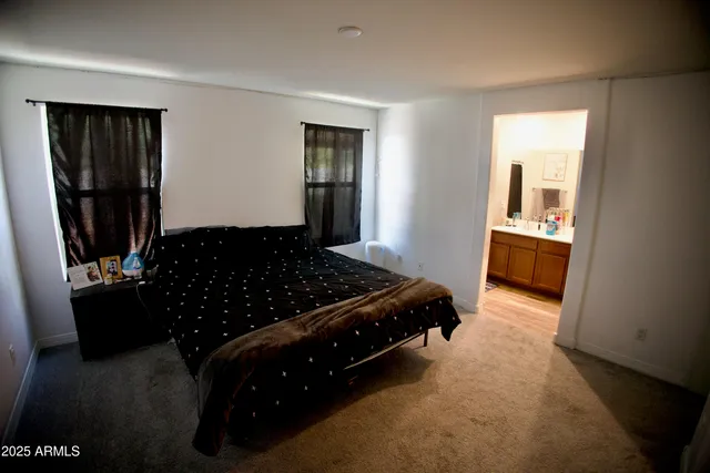 a bedroom with a bed and flat screen tv