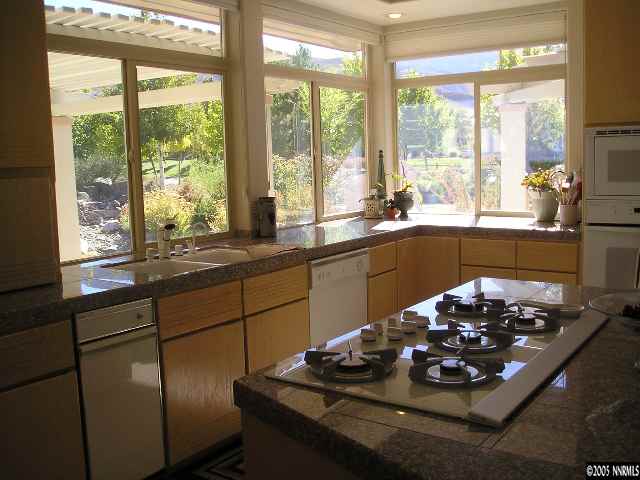 621 Meadowgate Court Reno, NV 89519 - Photo 4 of 9 a kitchen with a large window sink and stove