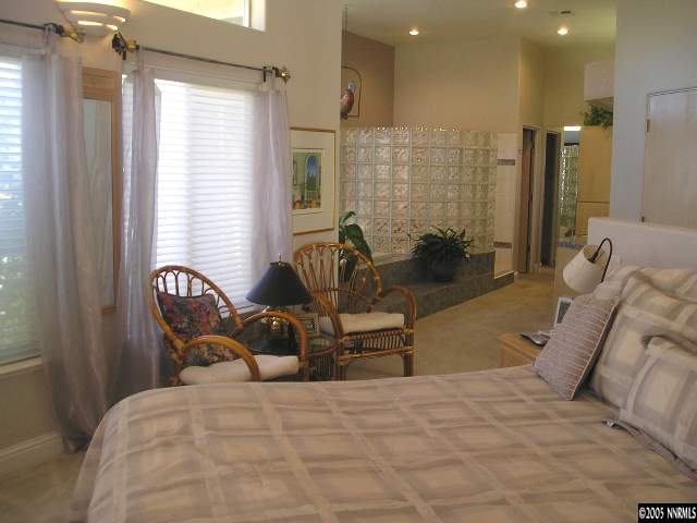 621 Meadowgate Court Reno, NV 89519 - Photo 6 of 9 a bedroom with a bed and wooden floor