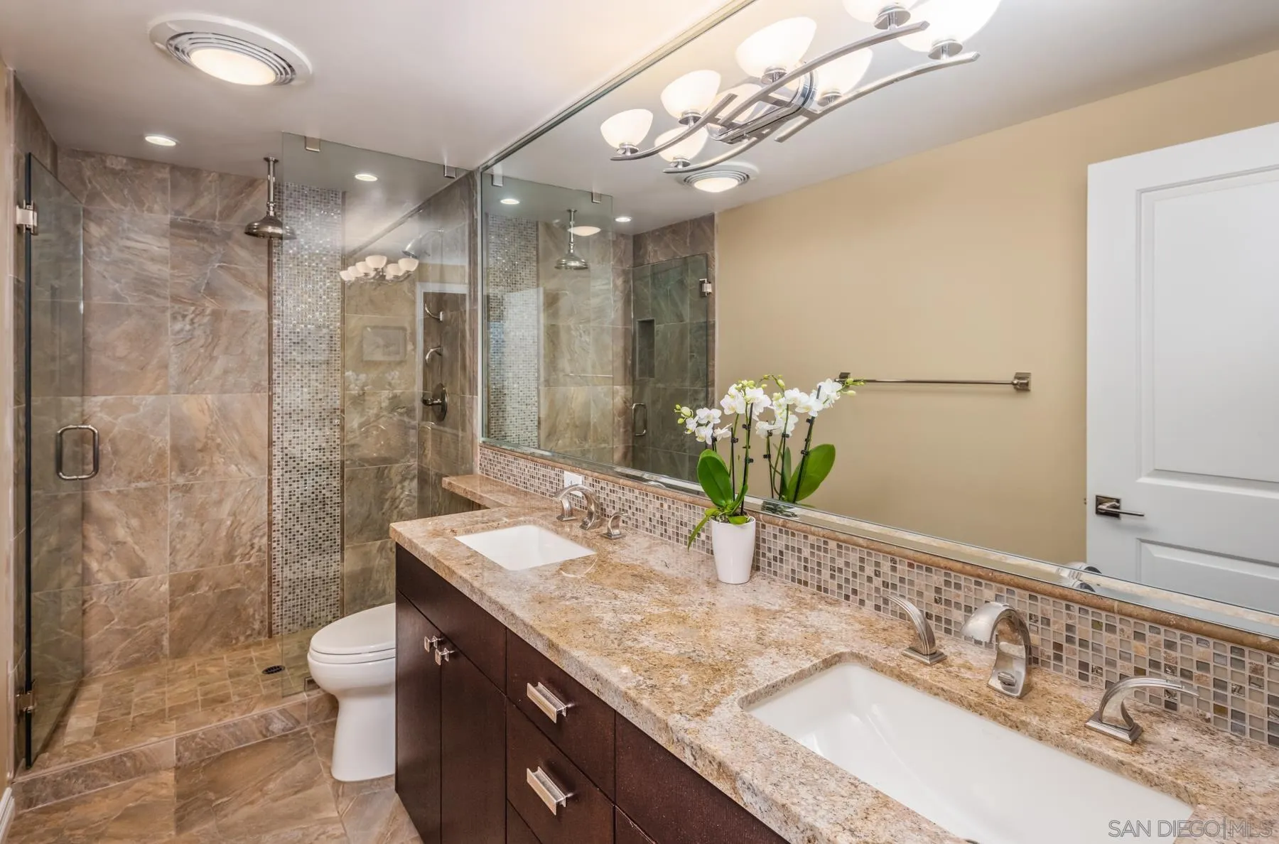 89 Trinidad Bend Coronado, CA 92118 - Photo 23 of 40 a bathroom with a granite countertop sink a toilet and shower