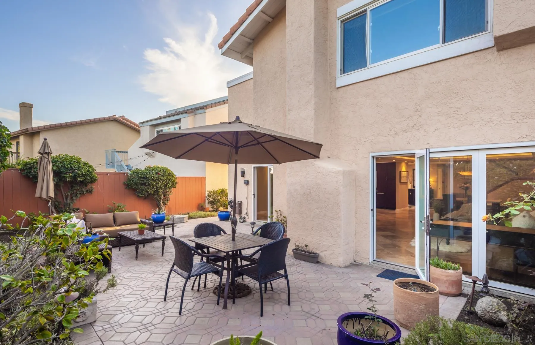 89 Trinidad Bend Coronado, CA 92118 - Photo 31 of 40 a view of a patio with chairs and table under an umbrella