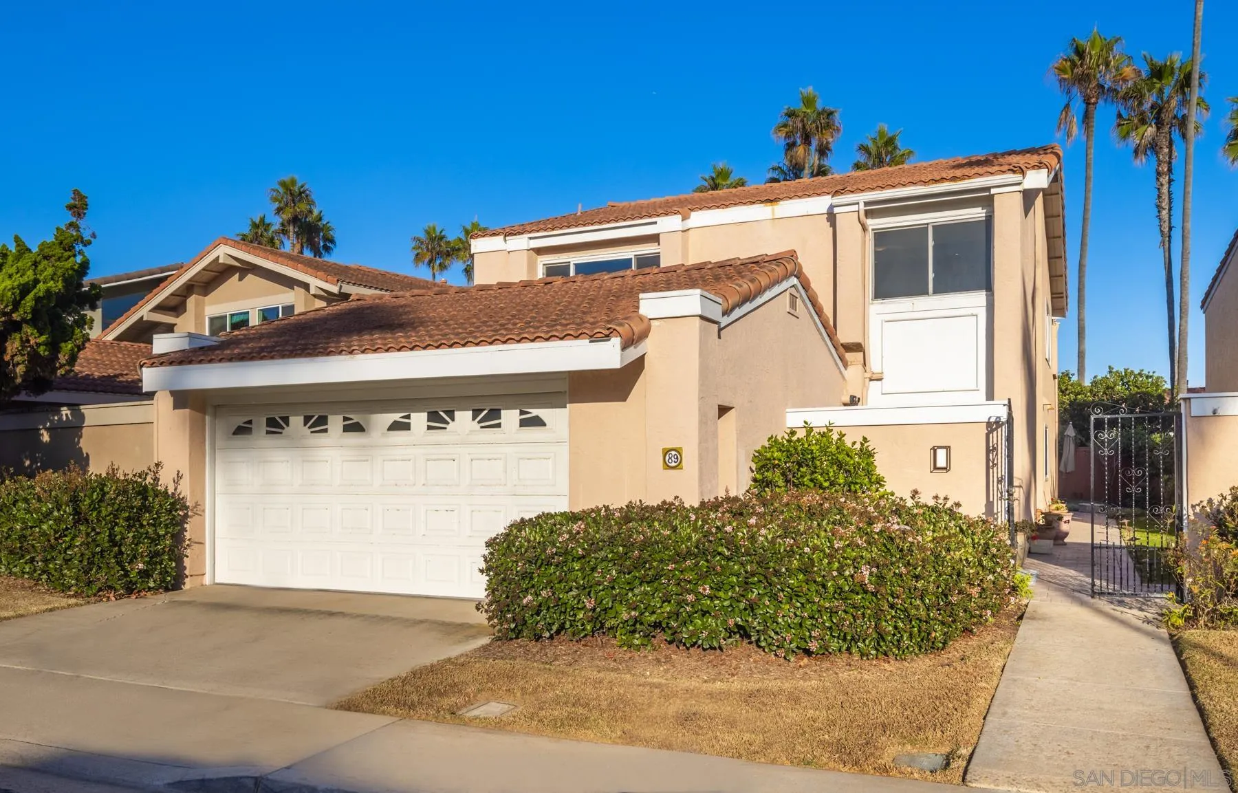 89 Trinidad Bend Coronado, CA 92118 - Photo 35 of 40 a front view of a house with a yard and garage