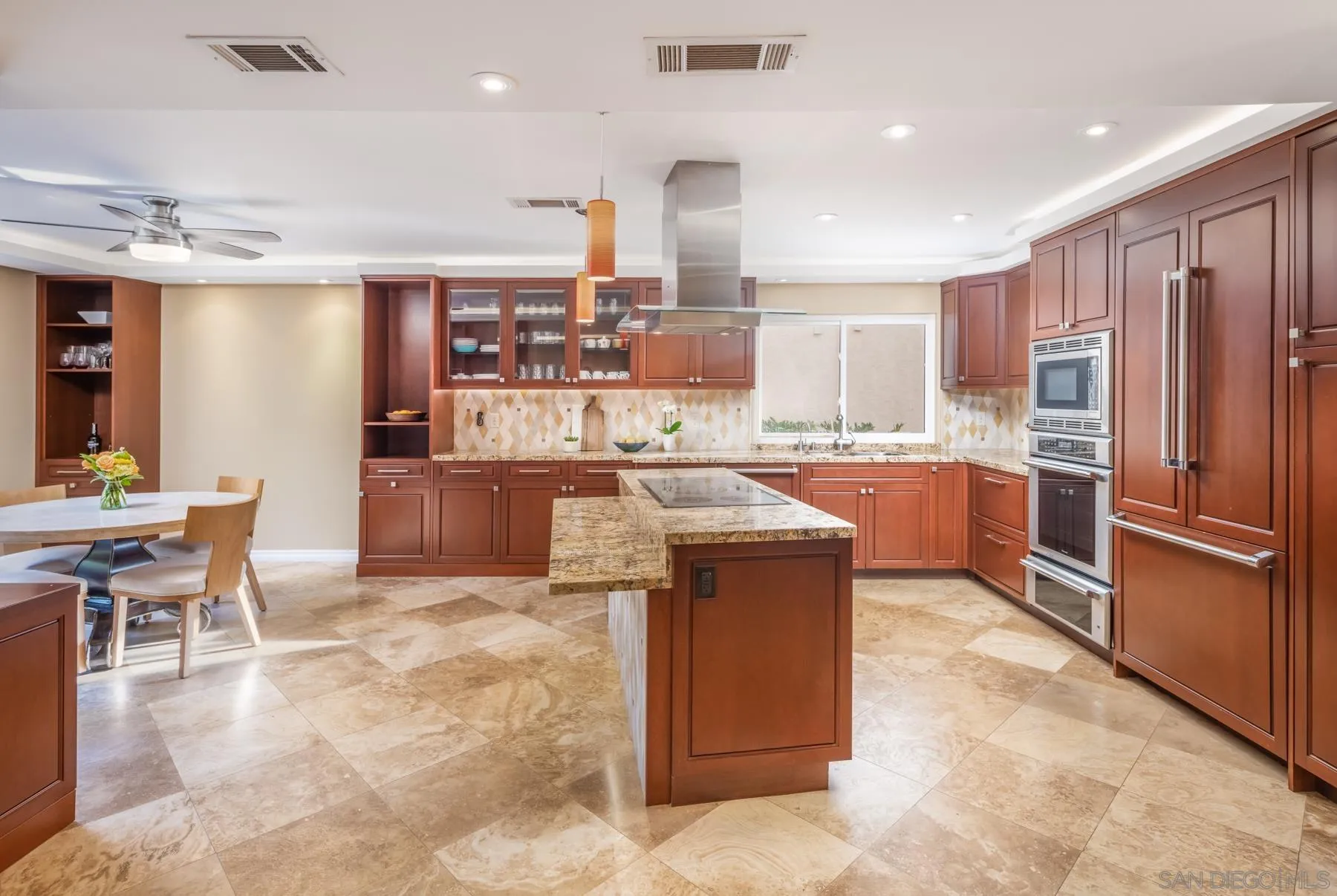 89 Trinidad Bend Coronado, CA 92118 - Photo 10 of 40 a kitchen with stainless steel appliances granite countertop a table chairs sink and cabinets