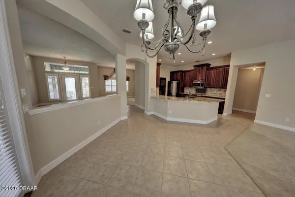 a view of a livingroom with a dinning area furniture and a chandelier